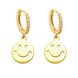 Elegant gold hoop earrings with sparkling cubic zirconia and a hanging cutout smiley face charm