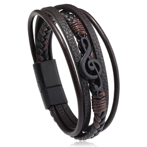 Detail of multi-layer braided leather bracelet with black musical treble clef and magnetic clasp