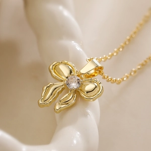 Polished 18K gold-plated bow necklace with a sparkling cubic zirconia stone pendant