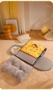 Detail showing the foldable pet house with a zipper, handle, and plush cushion for warmth
