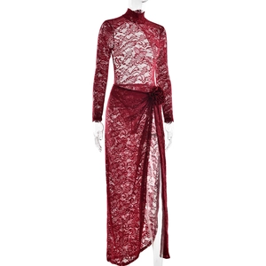 Detailed view of burgundy lace bodysuit and side slit skirt with floral waist accent