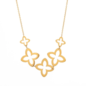 Detail view of gold-tone hollow four-leaf clover pendant on a delicate link necklace