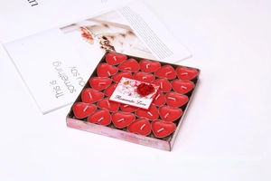 Close-up of fifty red heart-shaped tea light candles in transparent plastic packaging
