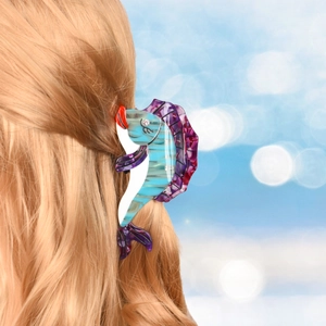 Detail of seahorse acetate hair claw with colorful rhinestones on blonde hair