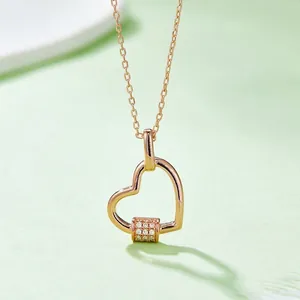 Elegant rose gold S925 silver heart necklace with moissanite diamond on green surface