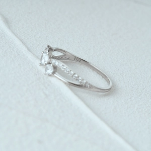 Macro shot of S925 sterling silver ring band with pave set diamonds and hallmark