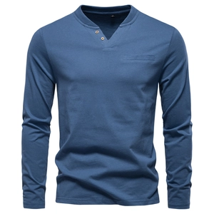 Detail view of navy blue long sleeve Henley shirt featuring a V-neck with buttons and soft cotton texture