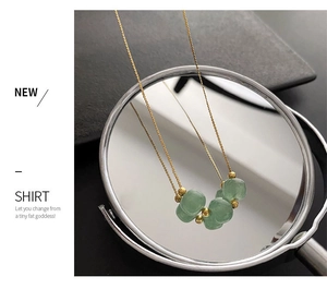 Detailed macro view of green jade beads and gold titanium steel chain for women