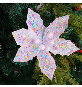Close-up of a purple macaron Christmas flower ornament with pink beads on pine branches