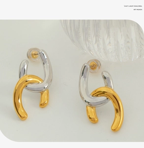 Detail view of geometric U-shaped earrings in mixed silver and gold finish design
