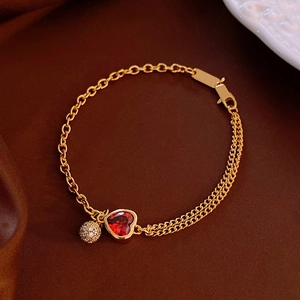 18k gold plated bracelet featuring a red heart stone and crystal charm on satin