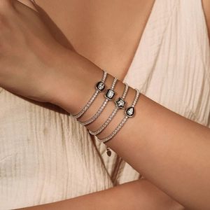 Stacked S925 silver tennis bracelets with black enamel geometric charms and crystals