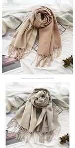 Macro detail of gradient cashmere-like scarf with fringe on elegant display rack