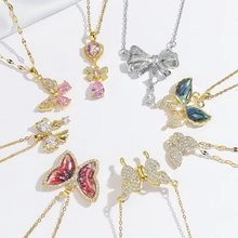 Collection of colorful butterfly and bow necklaces with crystal pendants in gold and silver