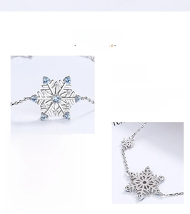 Detailed close-up showing the 925 sterling silver snowflake pendant with blue gemstones