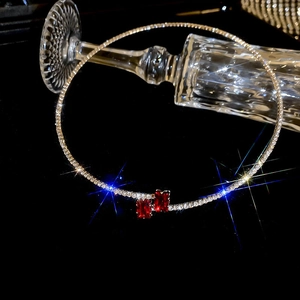 Detailed view of silver choker with dual rectangular red gemstones and pavé diamonds