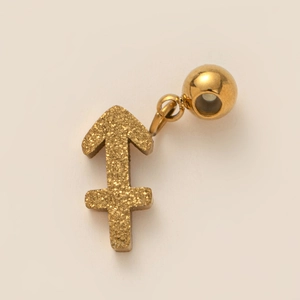 Macro shot of gold Sagittarius zodiac charm with sandblasted texture for necklaces