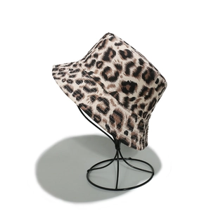 Detail of leopard print bucket hat on display stand showing canvas texture and pattern