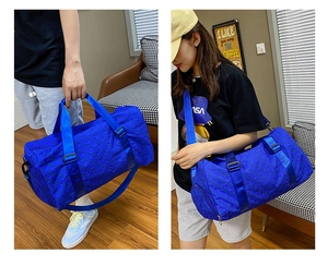 Blue large travel bag with 3D geometric texture shown by male and female models