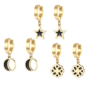 Three pairs of gold stainless steel hoop earrings with black star and moon charms