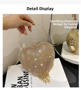Detail of heart-shaped gold evening bag with rhinestones, metal tassels and ring handle