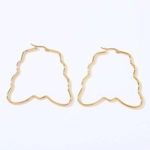Exaggerated geometric wavy hoop earrings in polished gold stainless steel on white back