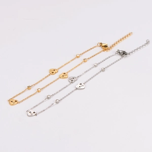 Golden and silver heart anklet set with crystal accents and LOVE engraving on white background