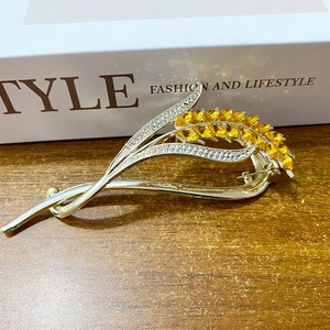 Golden wheat-shaped hair clip with yellow faceted crystals and sparkling rhinestones
