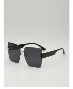 Detailed side view of oversized square sunglasses with black frame and golden bridge