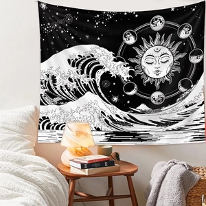 Detail view of black and white tarot tapestry with sun, moon phases and ocean waves