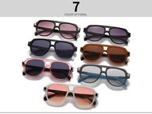 Flat lay of retro double-bridge oversized sunglasses in seven stylish assorted colors