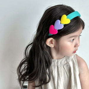 Kids colorful sponge headband featuring vibrant heart-shaped decor on a teal blue base