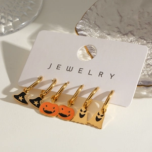 Halloween earring set with gold wizard hats pumpkins and ghosts on display card
