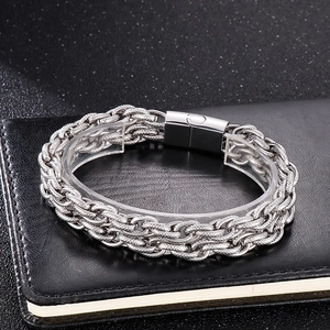 Détail d'un bracelet gourmette en acier inoxydable avec fermoir carré sur cuir