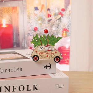 Detailed view of wood car ornament with Santa and Merry Christmas text on a tree