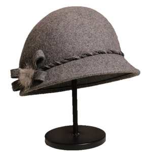 Elegant grey wool cloche hat for women featuring a bow and soft fur pompom detail