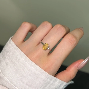 On-hand view of an S925 sterling silver ring with a yellow oval-cut gemstone center