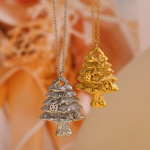 Detail of Christmas tree pendants in silver and gold 18K plated stainless steel