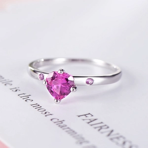 Elegant s925 silver ring featuring a sparkling pink heart-shaped stone and side gems