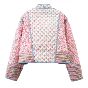 Back view of a reversible quilted jacket featuring pink and blue floral paisley patterns