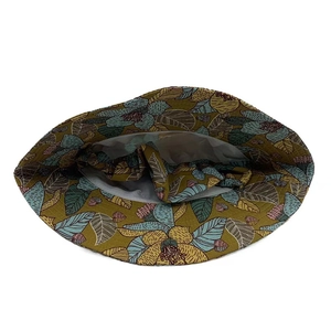 Detailed top view of a ginger floral sun hat with blue and pink vintage botanical patterns