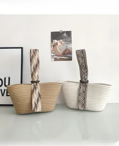 Detail of bohemian woven handbags with paisley straps and decorative wooden rings