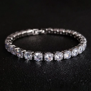 Macro shot of silver tennis bracelet with cubic zirconia in four-prong settings