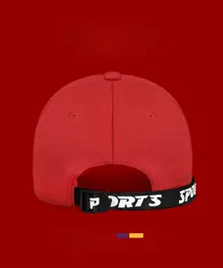 Detail of red baseball cap back with adjustable black strap and printed sports letters