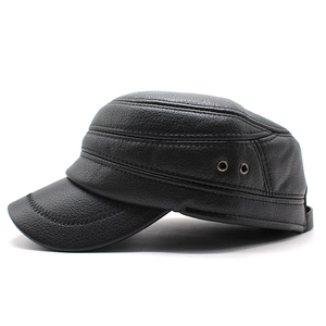 Detail view of black faux leather flat top hat with metal eyelets and reinforced stitching