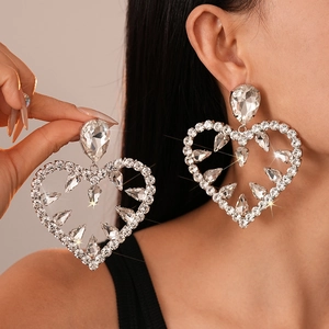 Exaggerated silver heart drop earrings with rhinestone hollow design for women