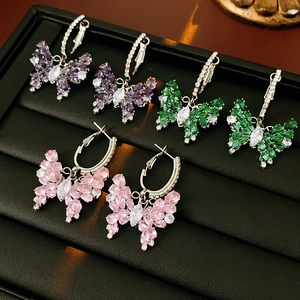 Detailed view of silver butterfly earrings with purple green and pink zirconia stones