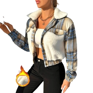 Detail of contrast plaid jacket featuring white faux fur collar and warm button-up closure