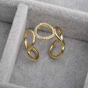Polished gold infinity open ring with micro-pave crystals on a grey velvet jewelry tray