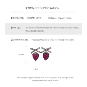 Detail view of strawberry bow earrings with precise size measurements and specifications